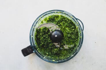 A food processor full of Cilantro Mint Sauce.