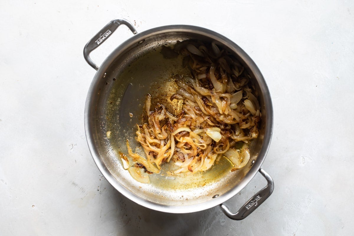 Onions sauteing in a Dutch oven.