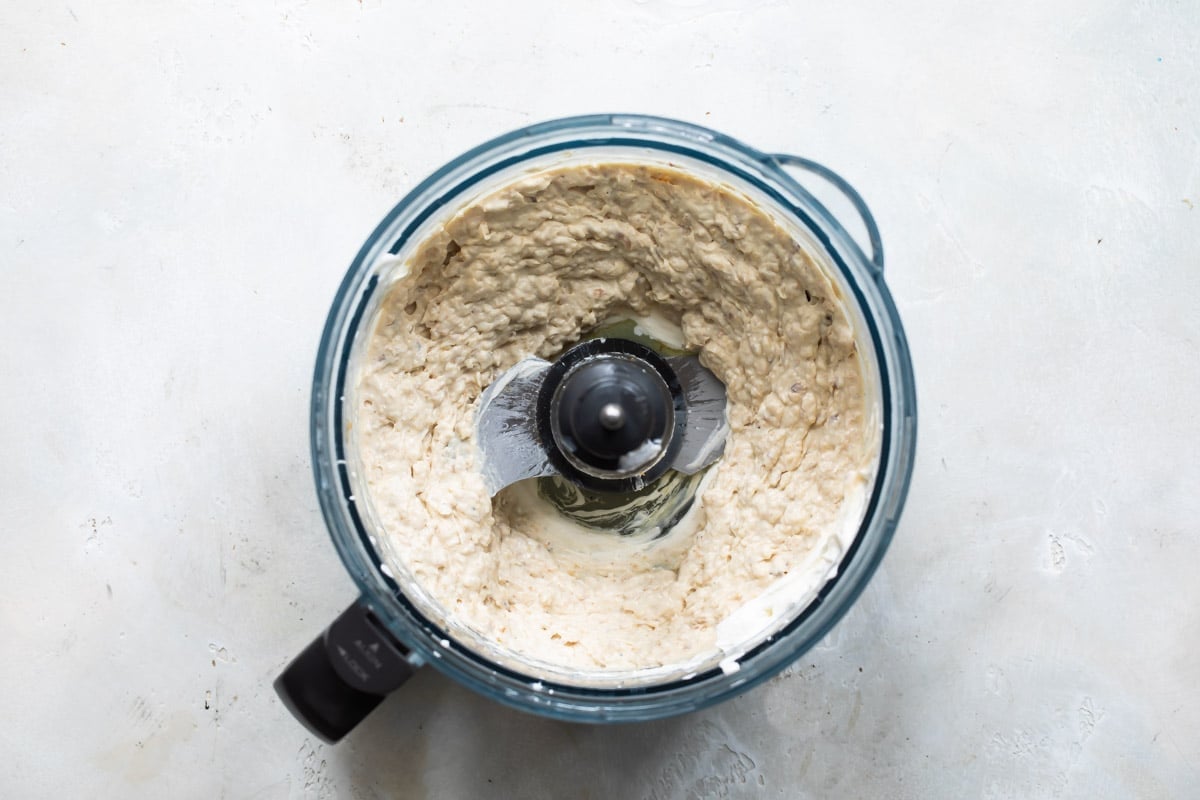 French onion dip being blended in a food processor.
