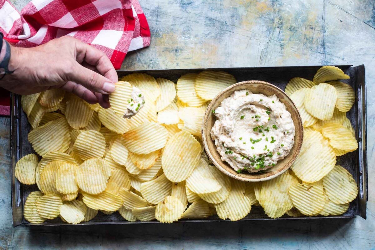 French onion dip and chips on a serving platter.