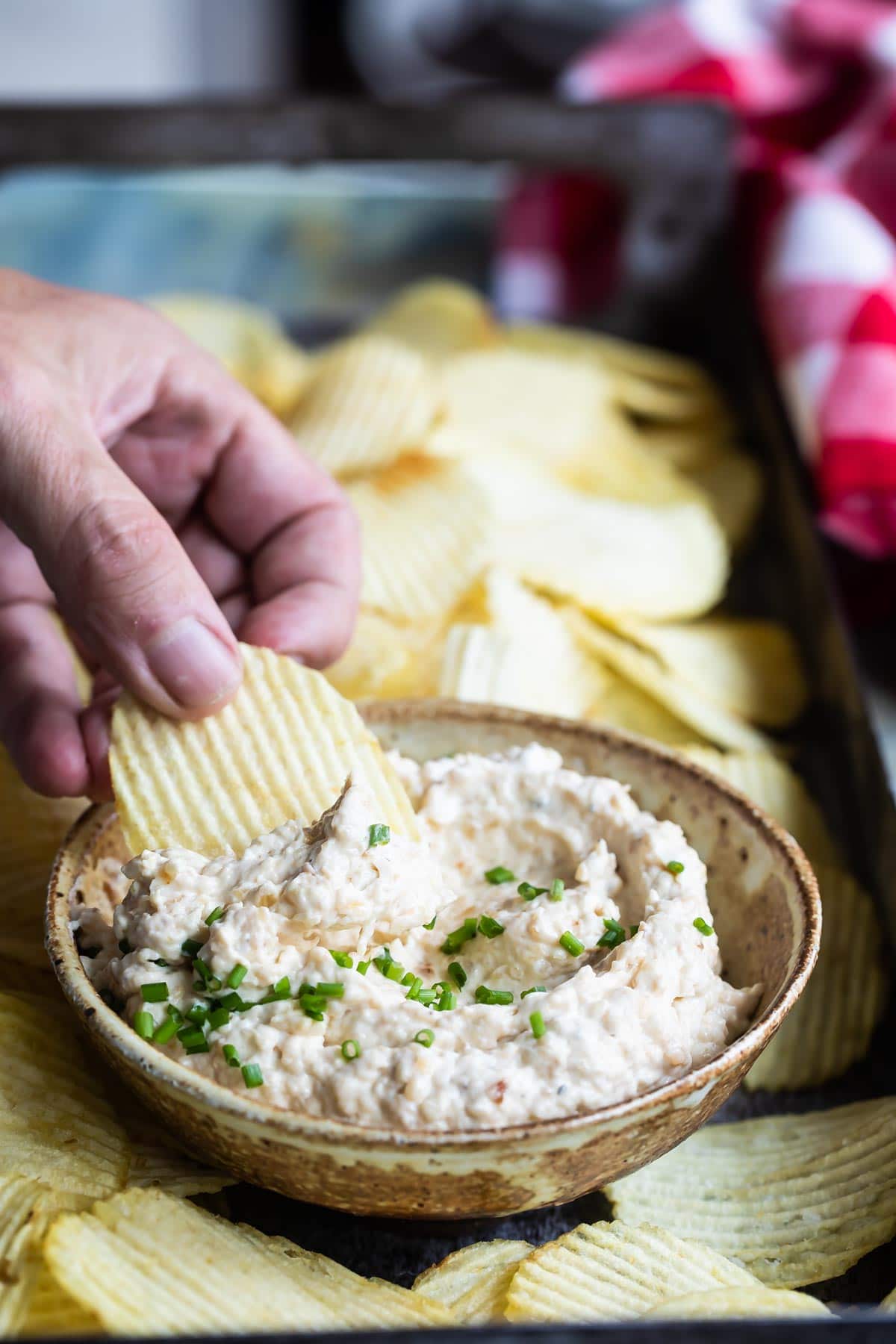 French onion dip and chips on a serving platter.