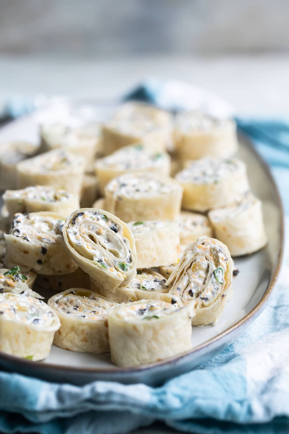 Slices of Mexican tortilla roll ups on a platter.