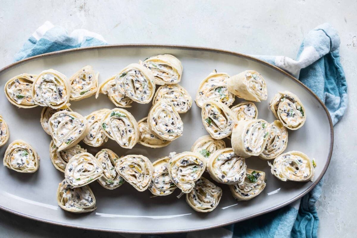 Slices of Mexican tortilla roll ups on a platter.