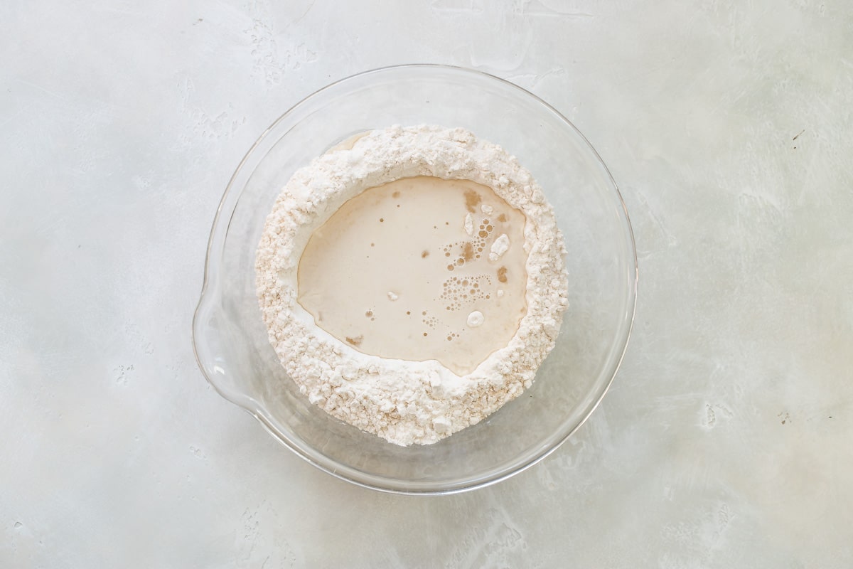 Mixing the ingredients for no knead bread dough in a bowl.