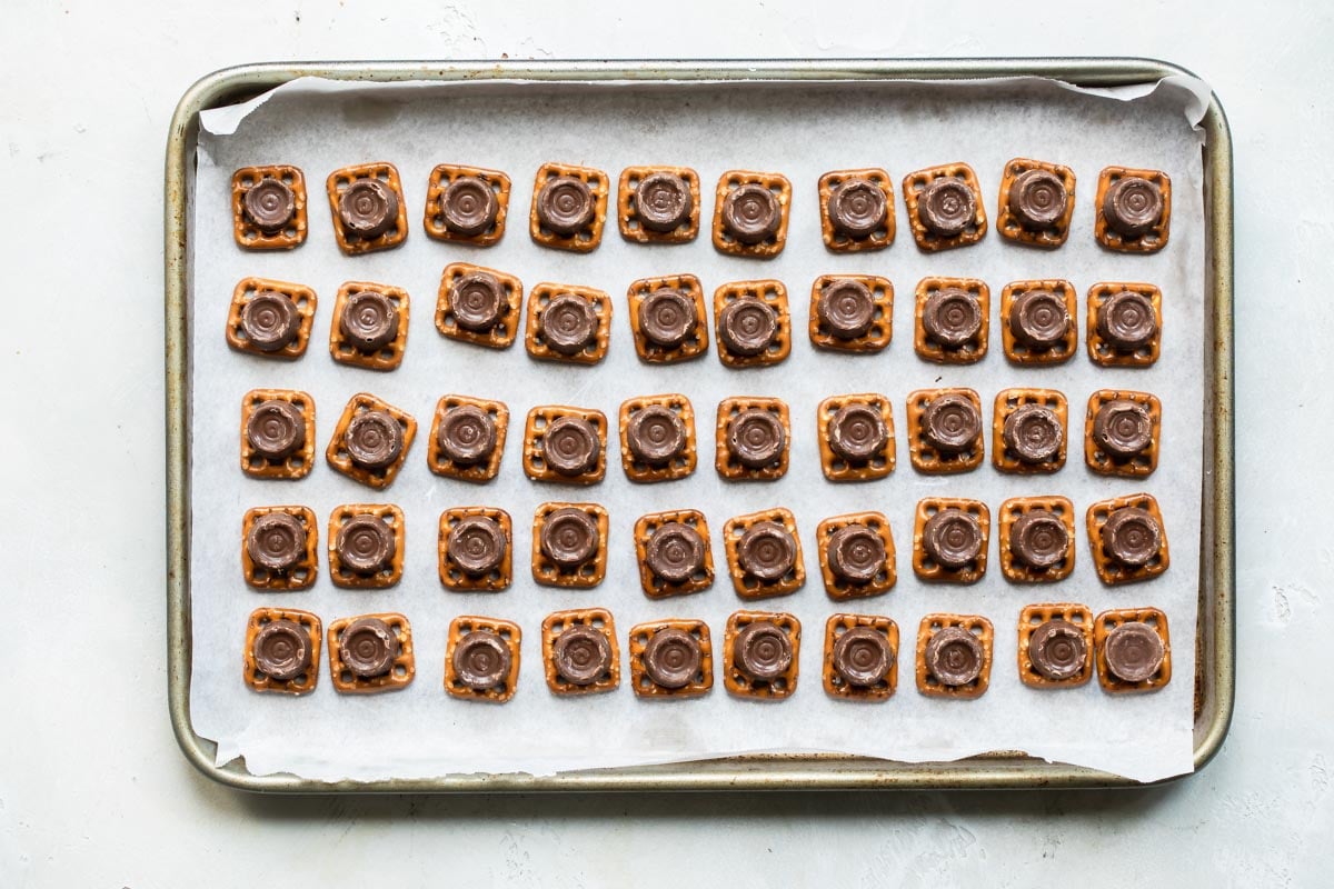 Rolo pretzels on a parchment lined baking sheet.