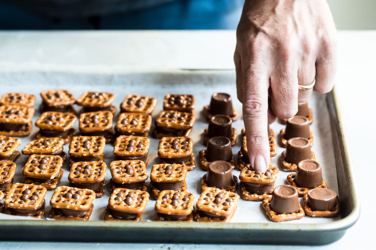 Assembling Rolo pretzel candies.