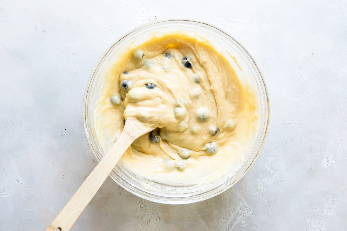 Blueberry lemon yogurt cake batter in a clear bowl.