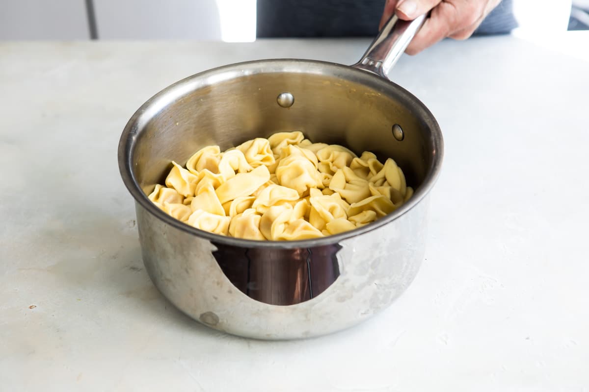 Cheese tortellini in a saucepan.