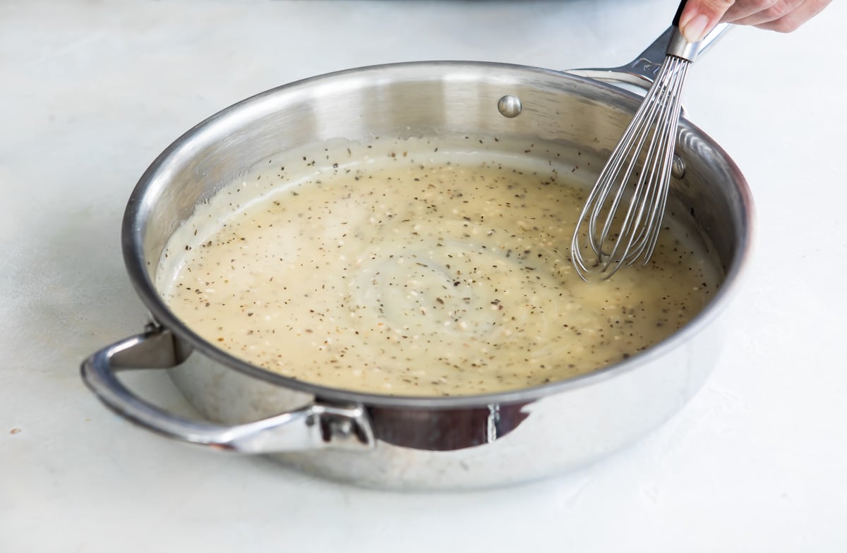 A garlic butter sauce in a skillet.