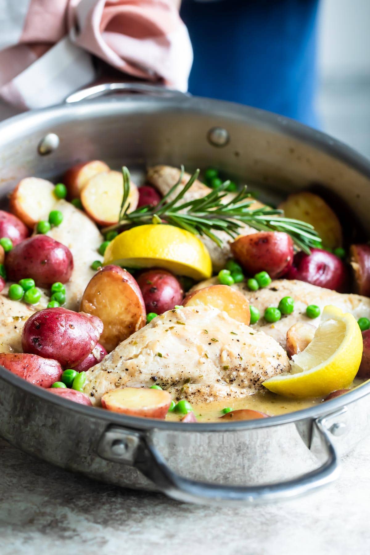 Chicken vesuvio in a silver skillet.