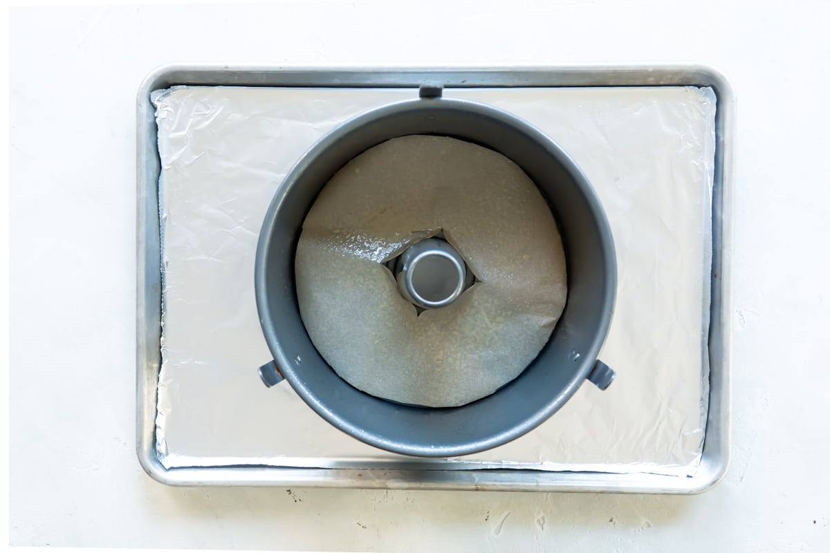 A tube pan with a piece of parchment paper in the bottom.