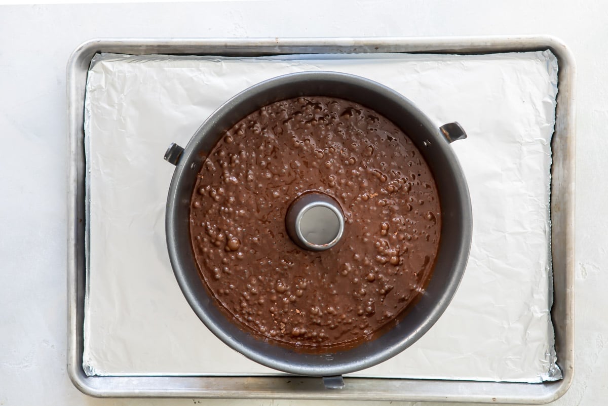Chocolate cake batter in a tube pan.