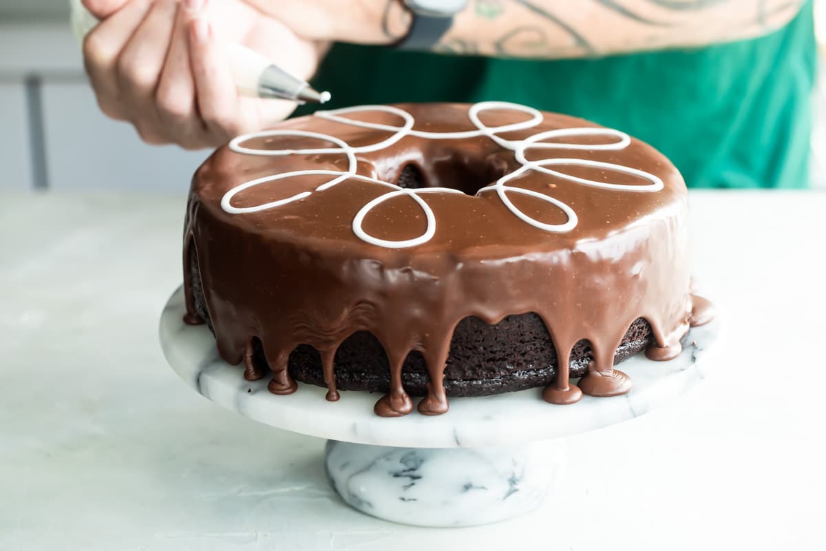 A ding dong cake on a marble cake stand.