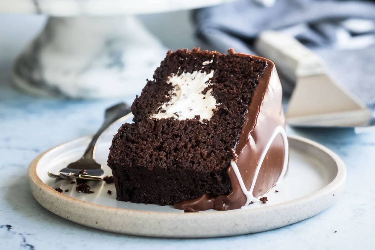 A slice of ding dong cake on a gray plate.