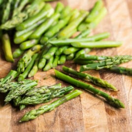Blanched asparagus on a cutting board.