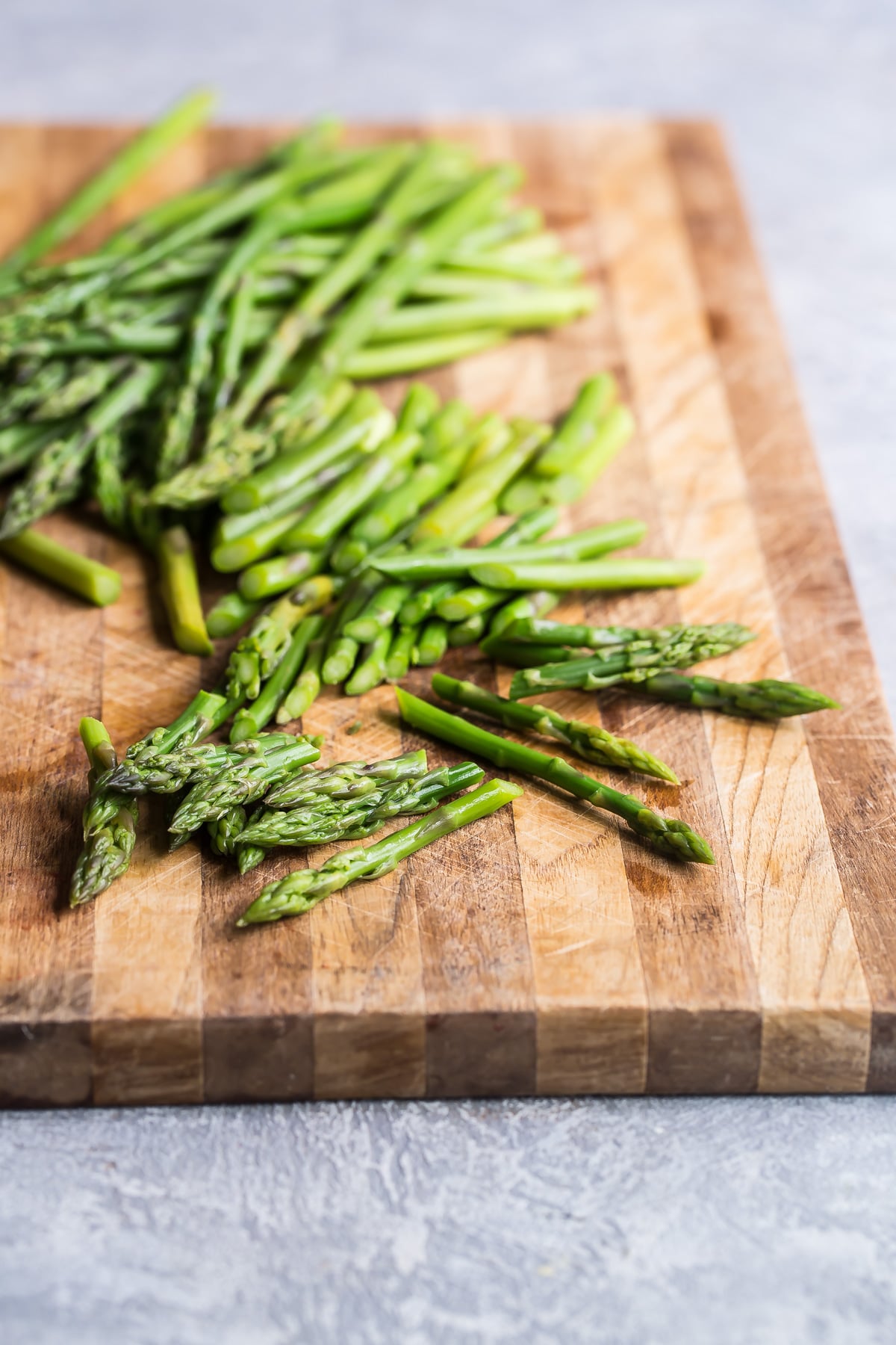 Blanched asparagus on a cutting board.