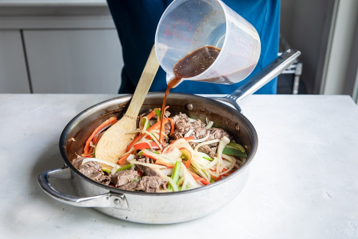 Adding stir fry sauce to Midwest Pepper Steak.