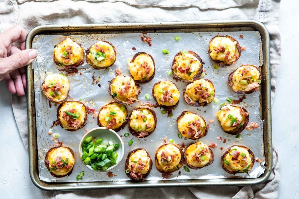 Mini twice baked potatoes on a silver baking sheet.
