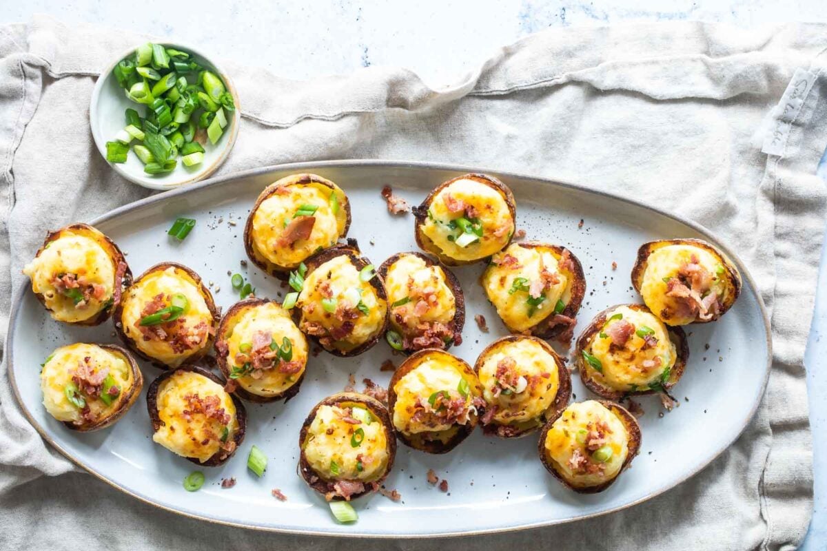 Mini twice baked potatoes on an oval serving platter.