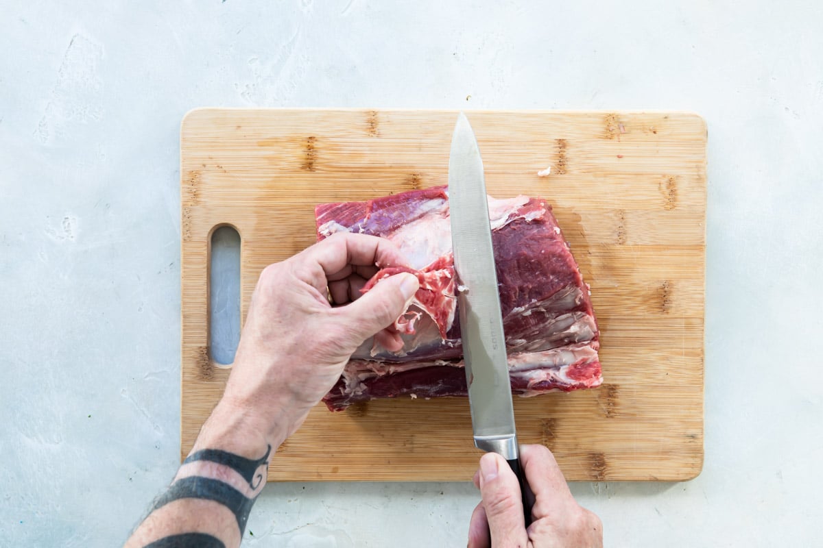 Trimming fat off a beef tenderloin.