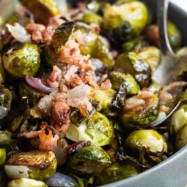 Roasted Brussels Sprouts with bacon in a gray dish.