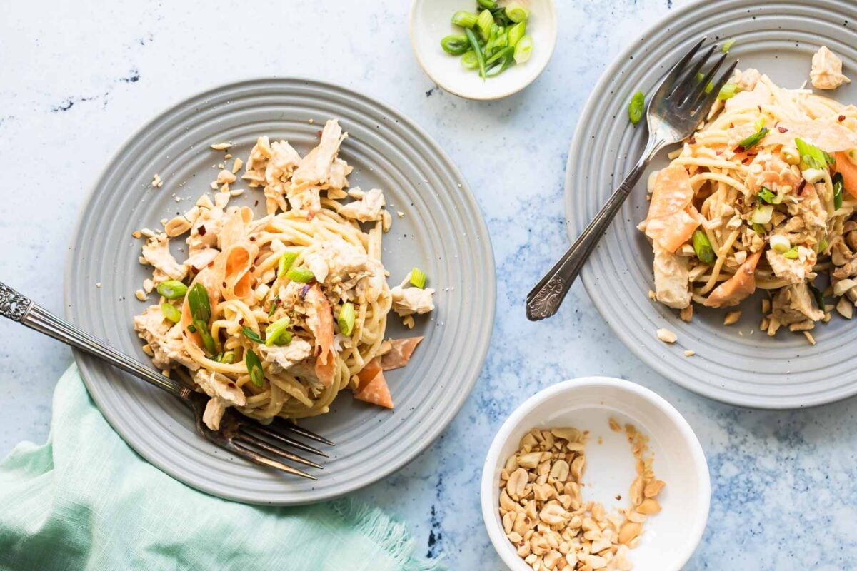 Thai peanut chicken noodles on a gray plate.