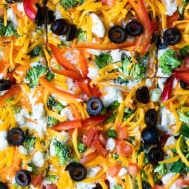 A veggie pizza cut into squares.