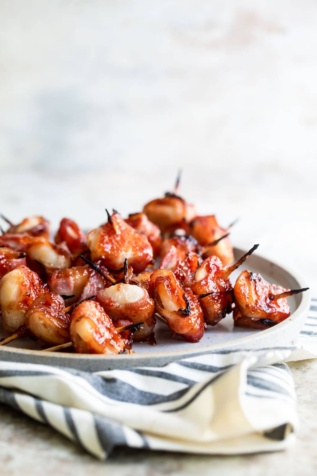 Bacon wrapped water chestnuts on a baking rack after being baked.