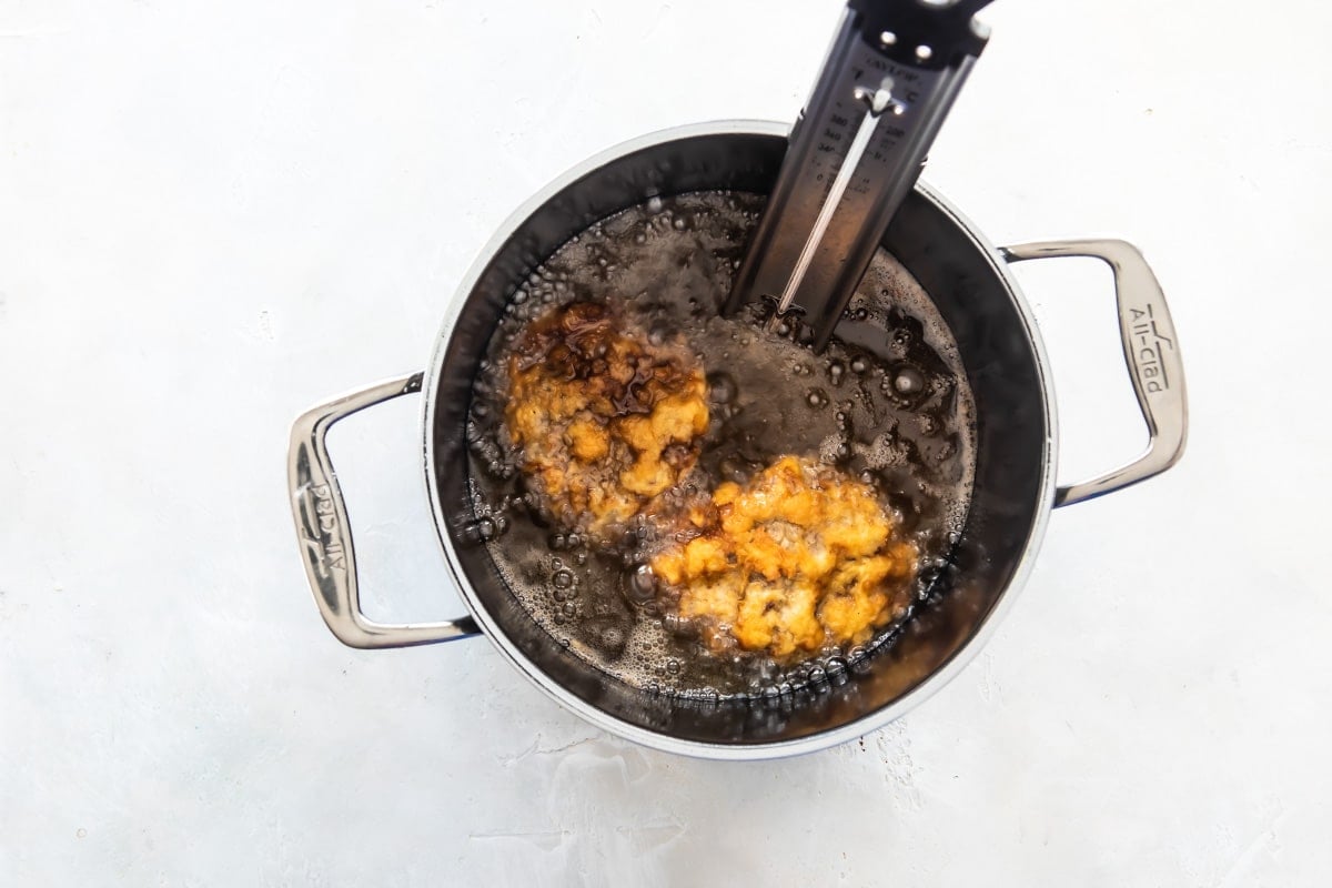 Country fried steak being deep fried.
