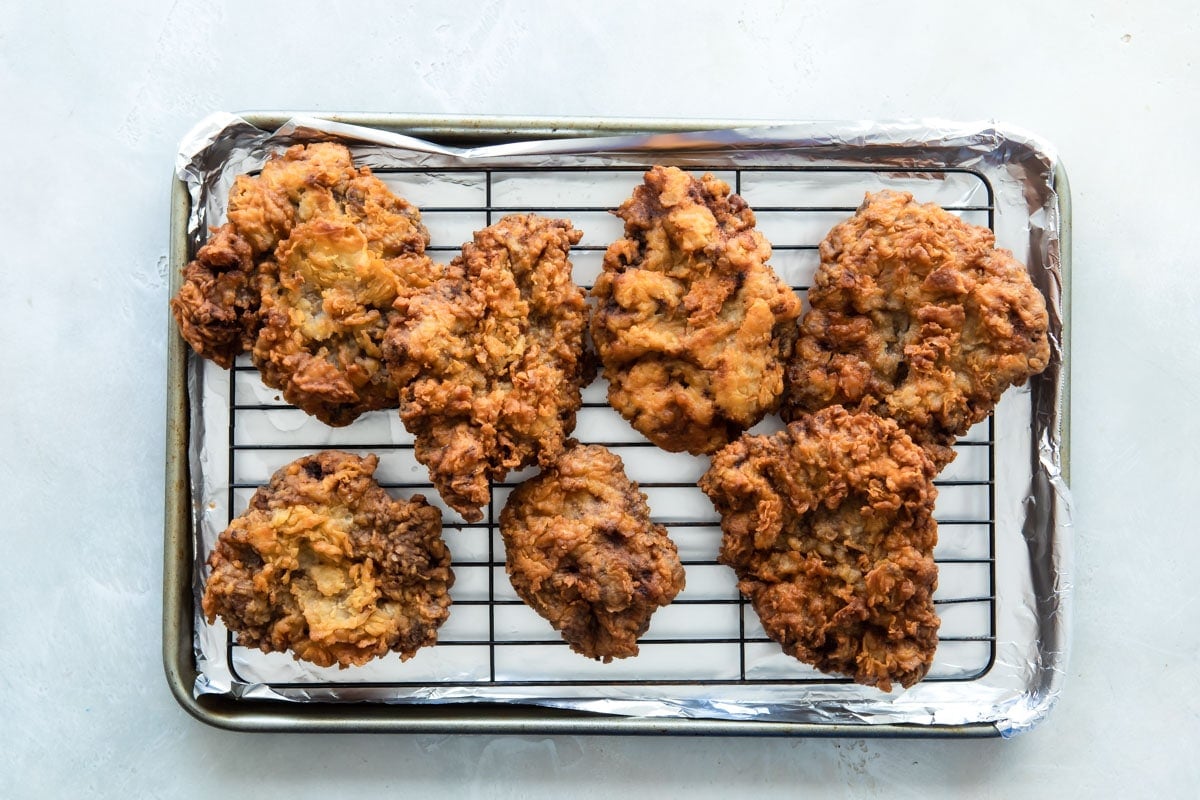 Country fried steak on a cooling rack.