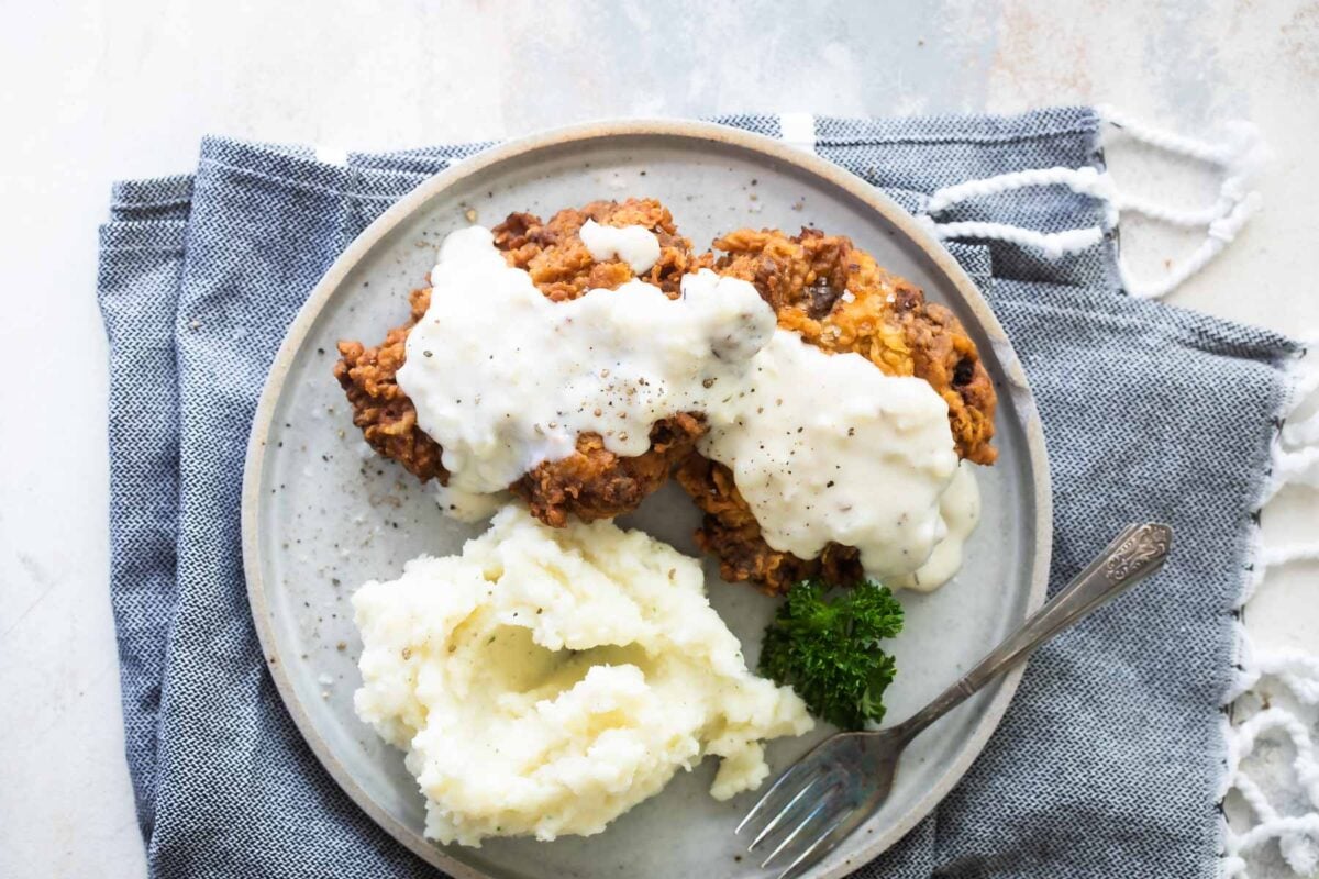 Country fried steak and mashed potatoes on a plate.