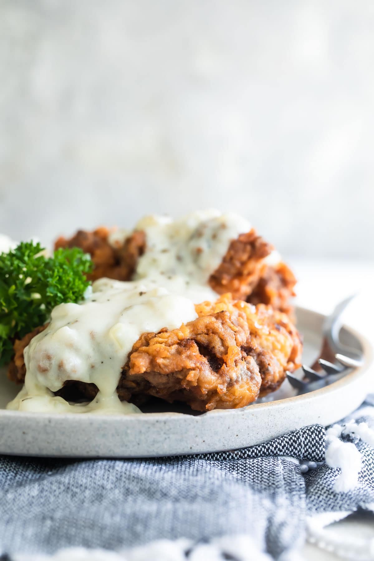 Country fried steak and mashed potatoes on a plate.