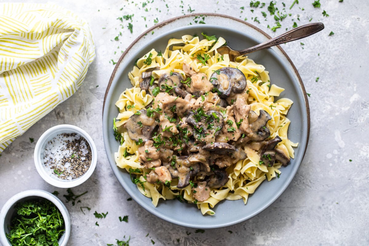 Chicken and mushroom stroganoff in a blue bowl.