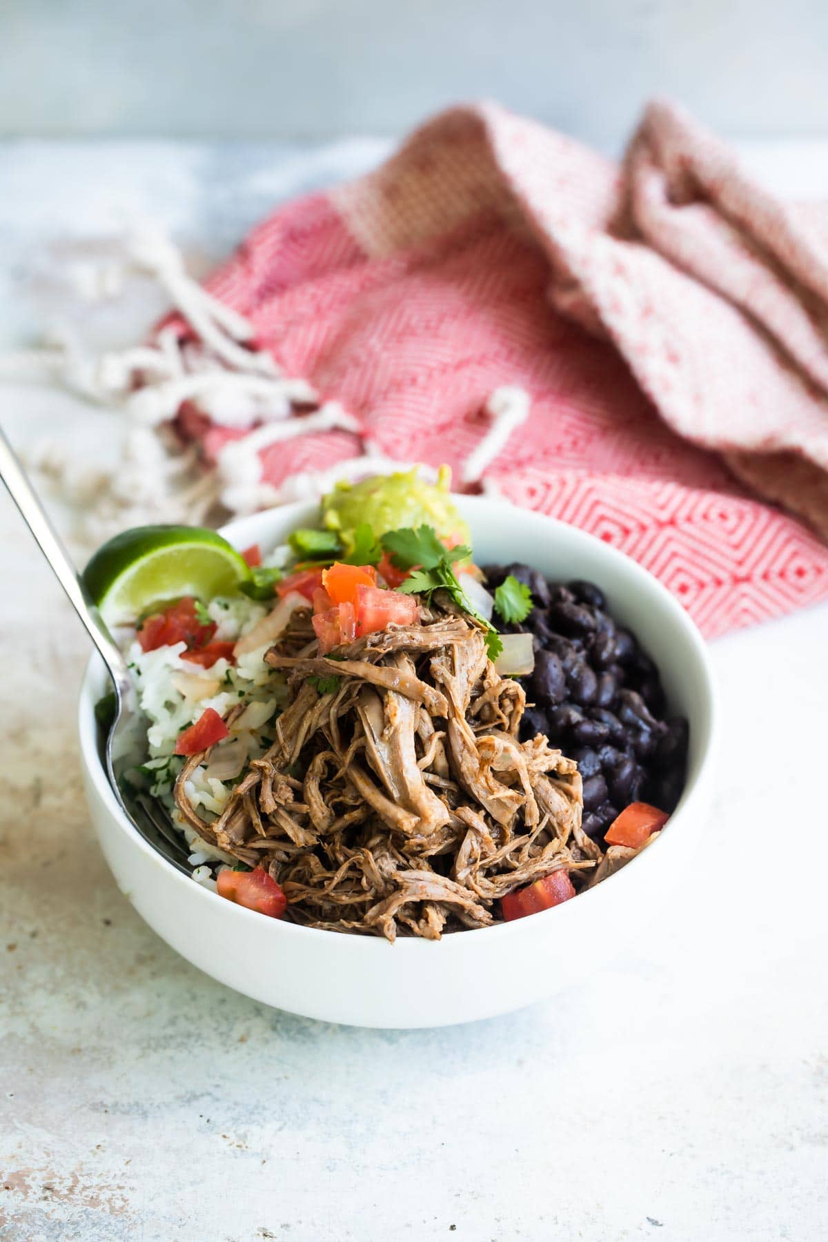 A bowl of Chipotle copycat Barbacoa beef with black beans, cilantro-lime rice, and pico de gallo salsa.