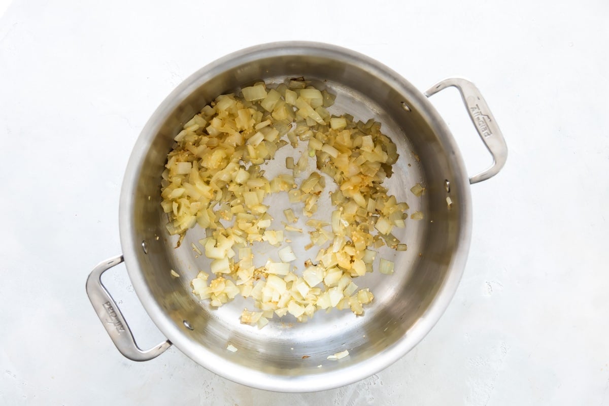 Cooking onion in a pot for black beans.