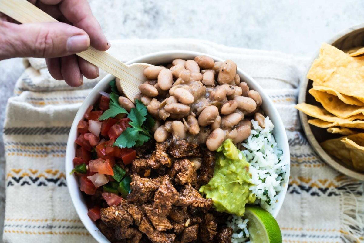 A bowl of Chipotle steak, pinto beans, cilantro-lime rice, and pico de gallo.