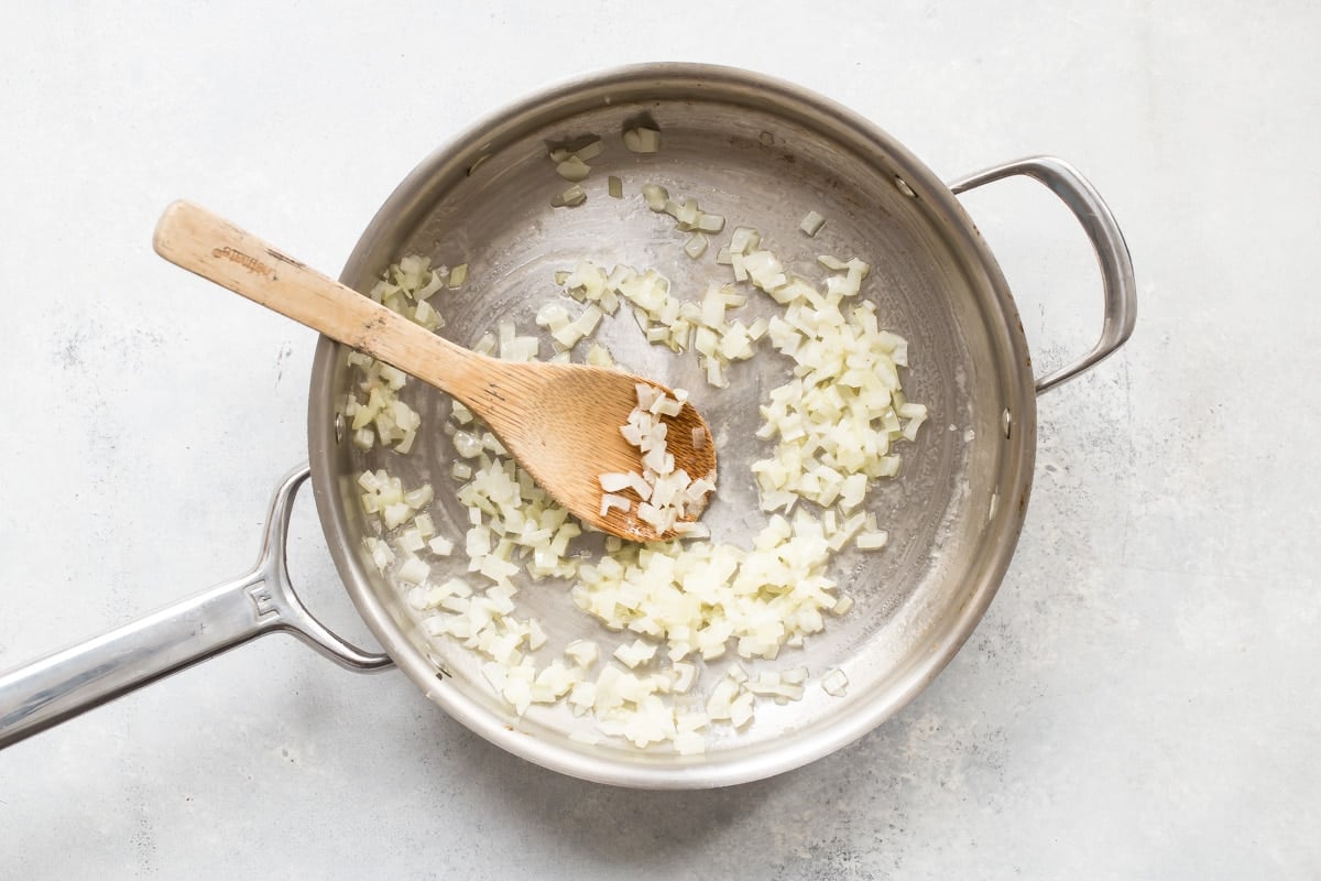 Onions sauteeing in a pan.