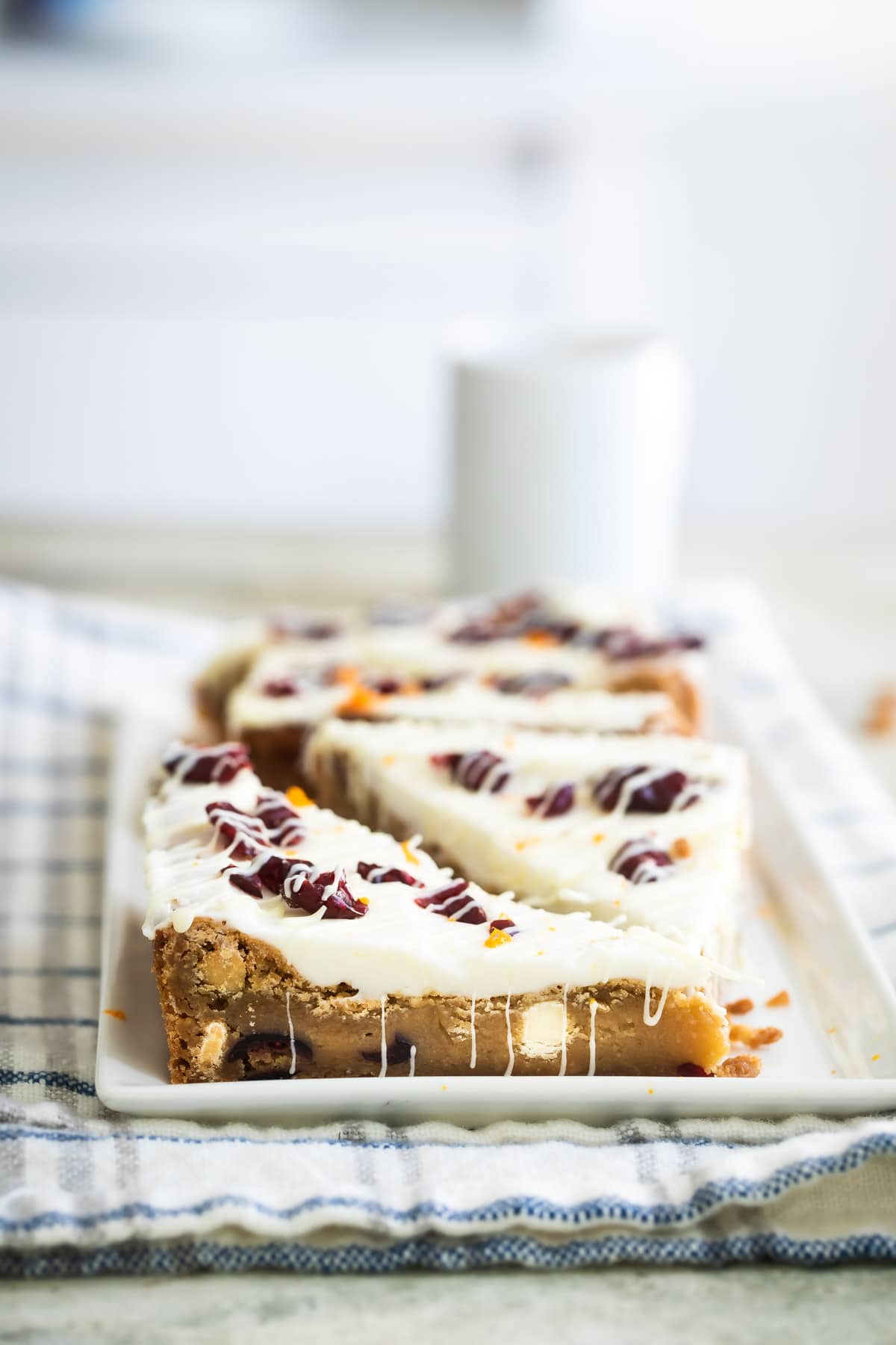 Cranberry bliss bar triangles on a white platter.