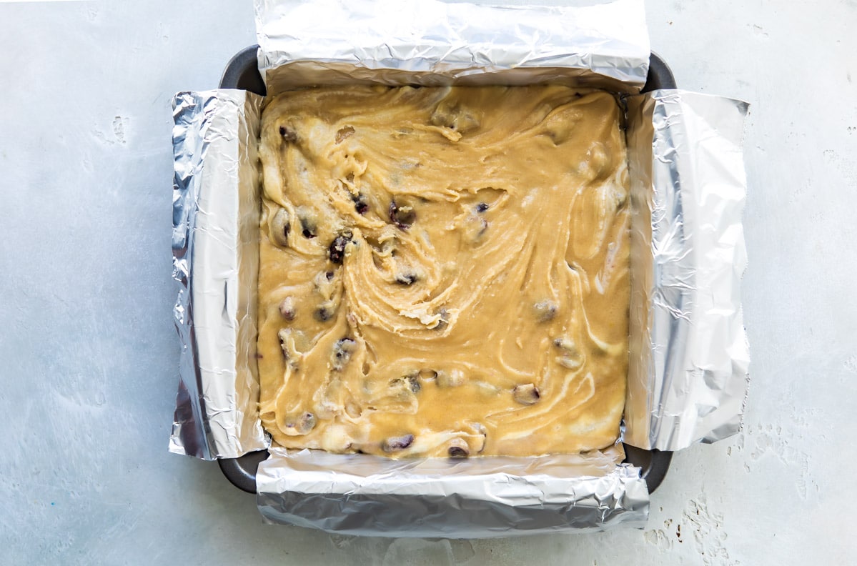 Cranberry bliss bar batter in a pan before being baked.