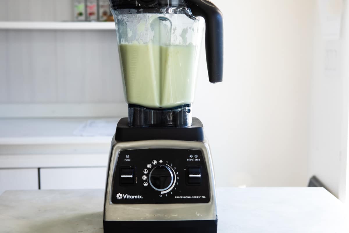 Blending cream of cauliflower soup in a blender.