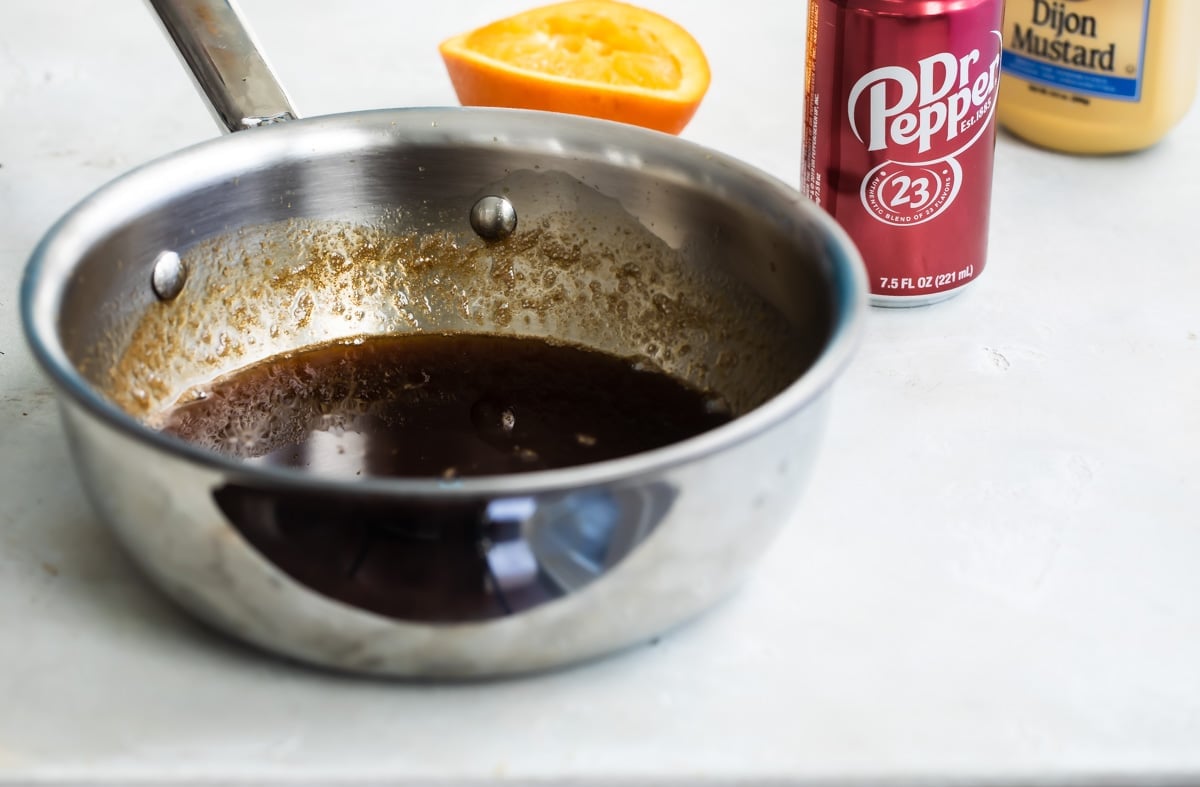 Dr. Pepper ham glaze in a silver skillet.