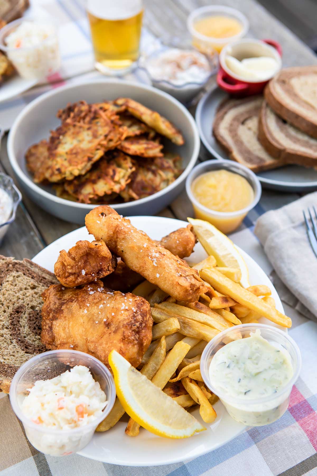 A fish fry set up outdoors on a picnic table.