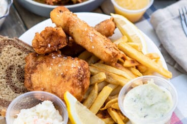 A fish fry set up outdoors on a picnic table.
