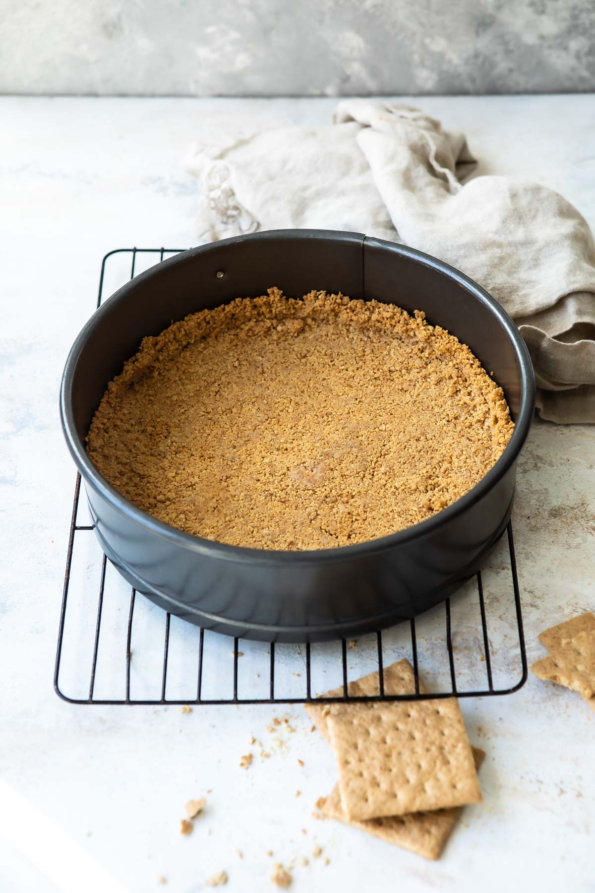A graham cracker crust in a springform pan.