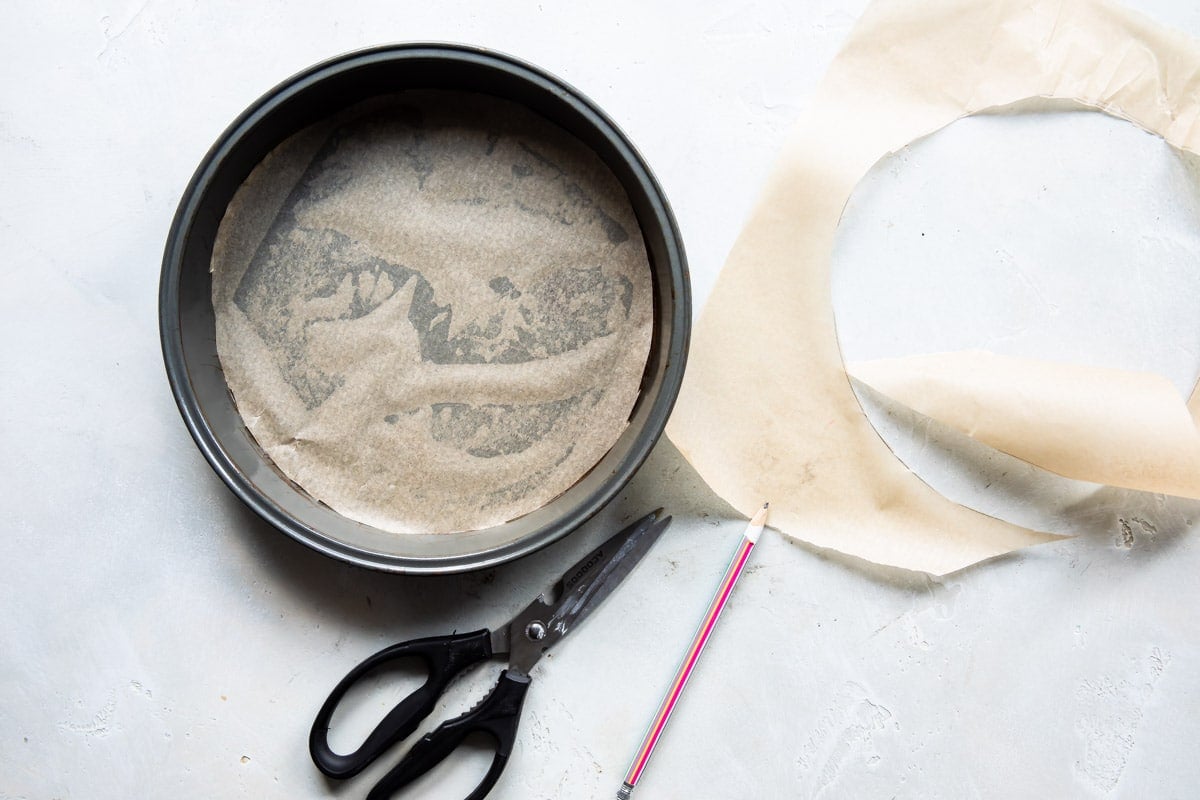 A parchment paper lined round cake pan.