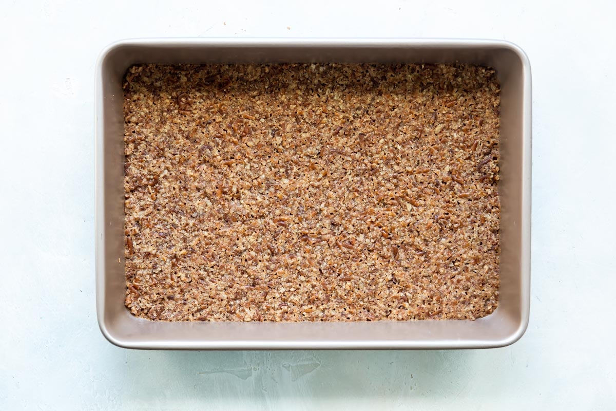 Pretzel crust in a baking pan.