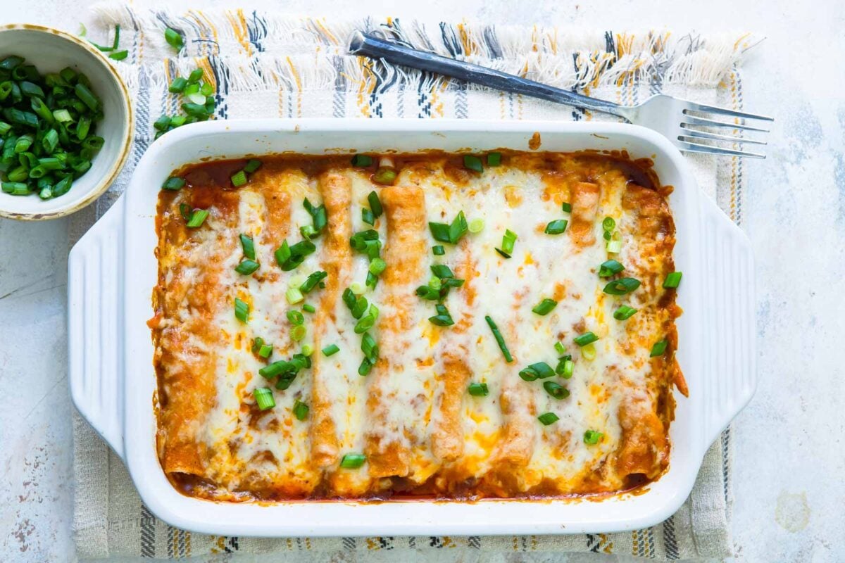 A casserole dish with chicken enchiladas.