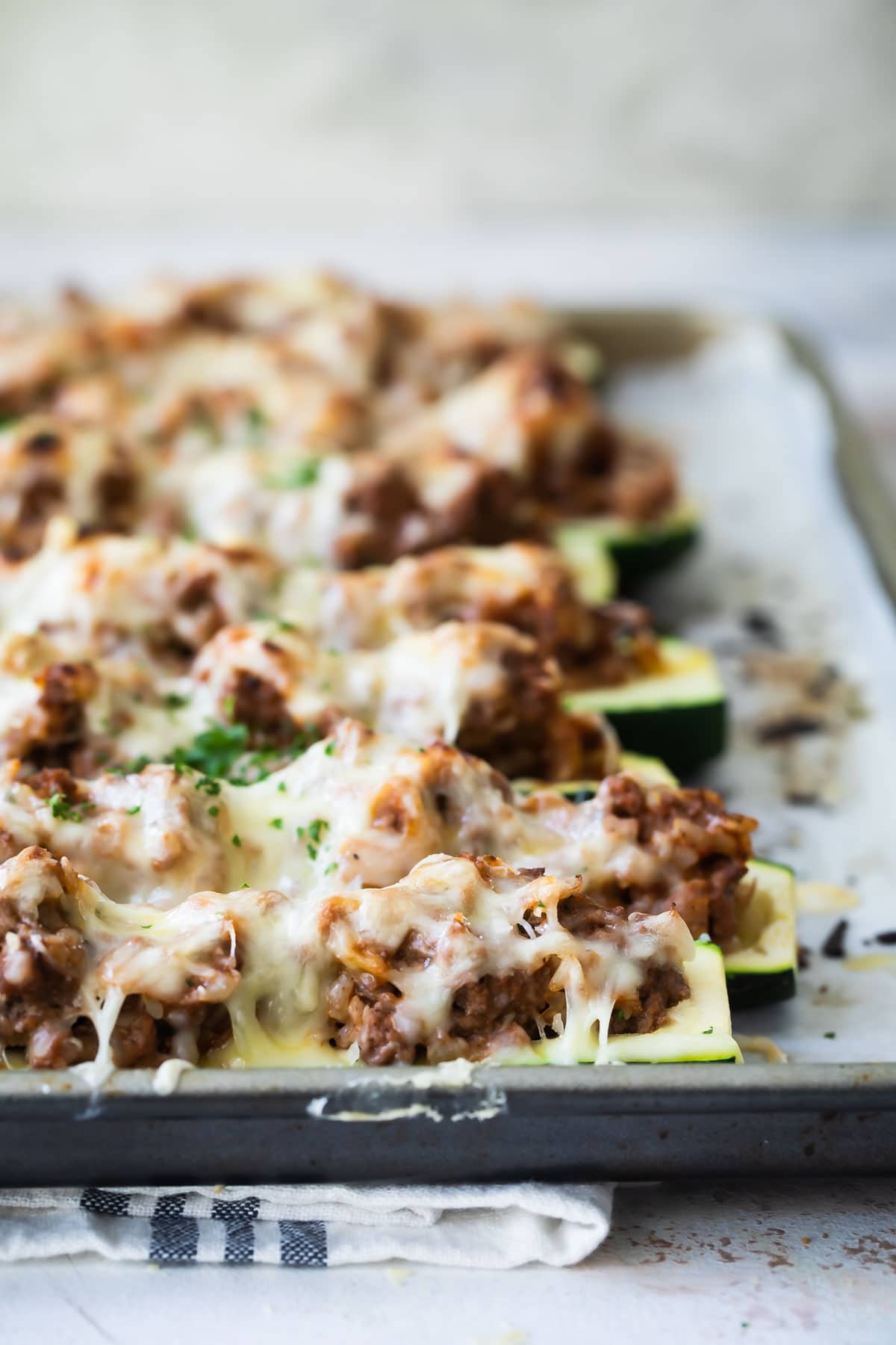 Stuffed zucchini on a baking sheet.