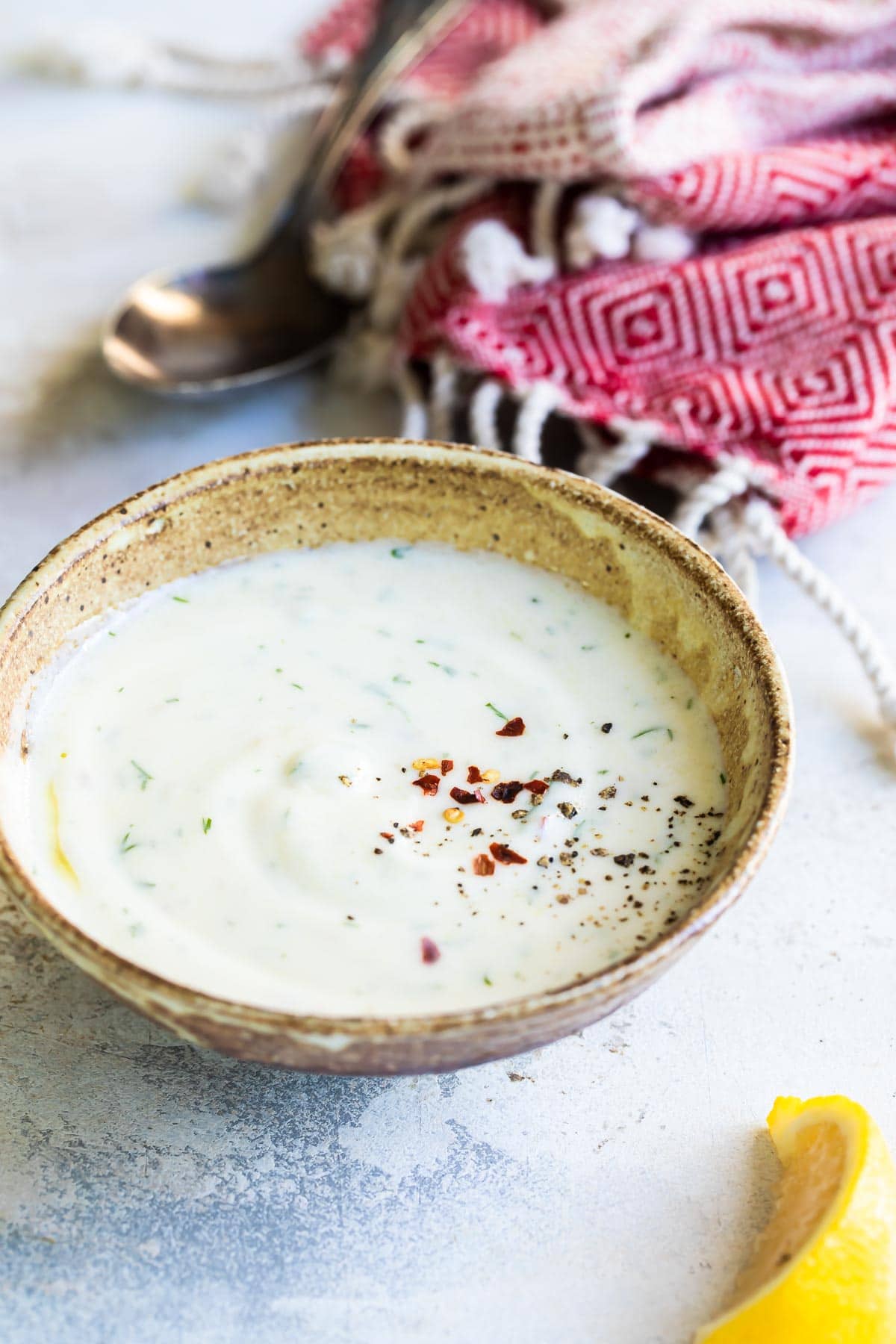 Yogurt sauce in a brown dish.