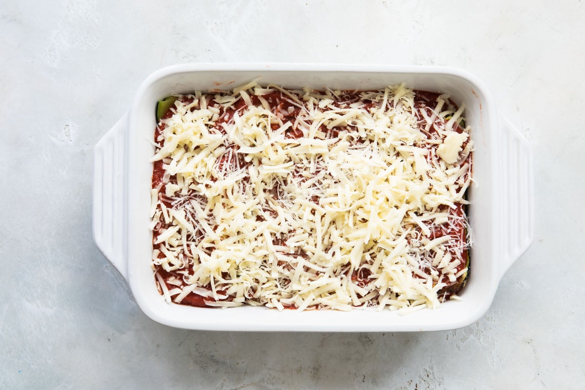 A baking dish of Zucchini Parmesan before being baked.